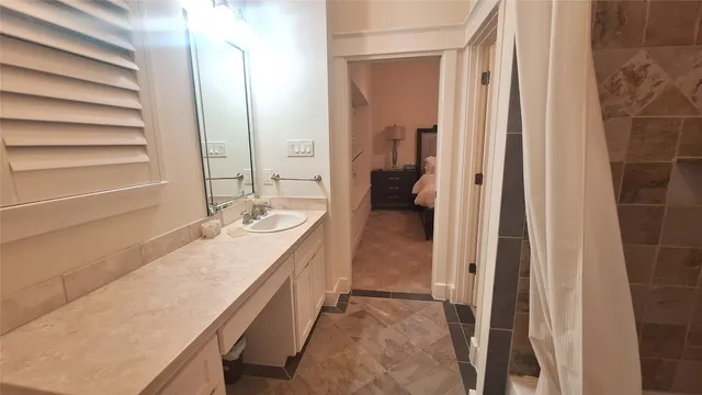 a bathroom with a sink a mirror and a shower