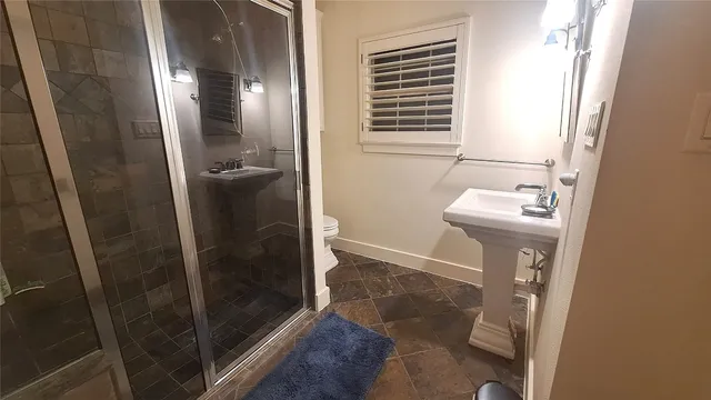 a bathroom with a sink a mirror and a shower