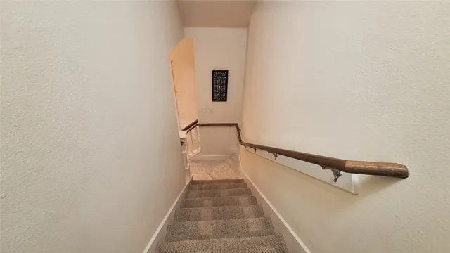 a view of a hallway with wooden floor and a hallway