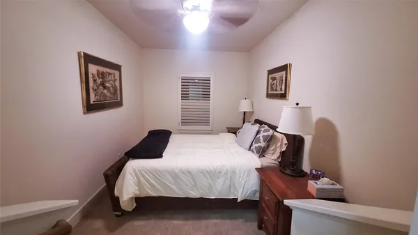 a bedroom with bed and a window