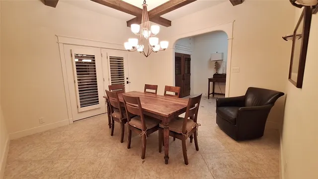 a view of a dining room with furniture and chandelier