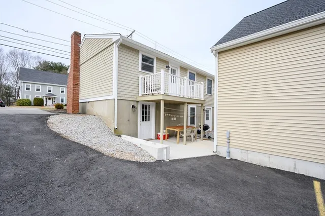 a view of a house with a patio and a yard