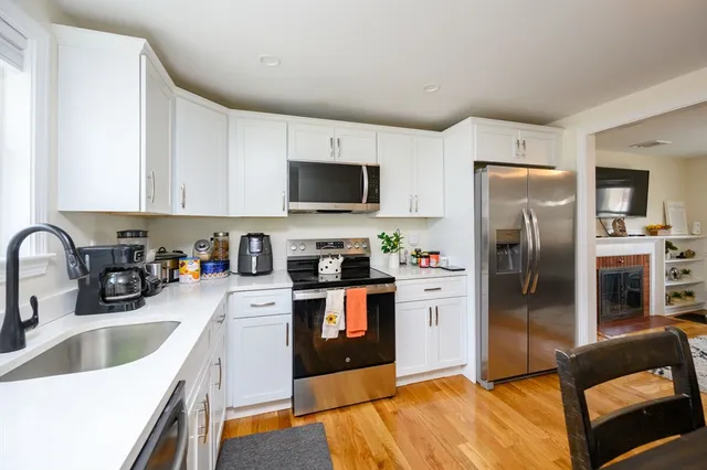 a kitchen with stainless steel appliances a refrigerator sink and microwave