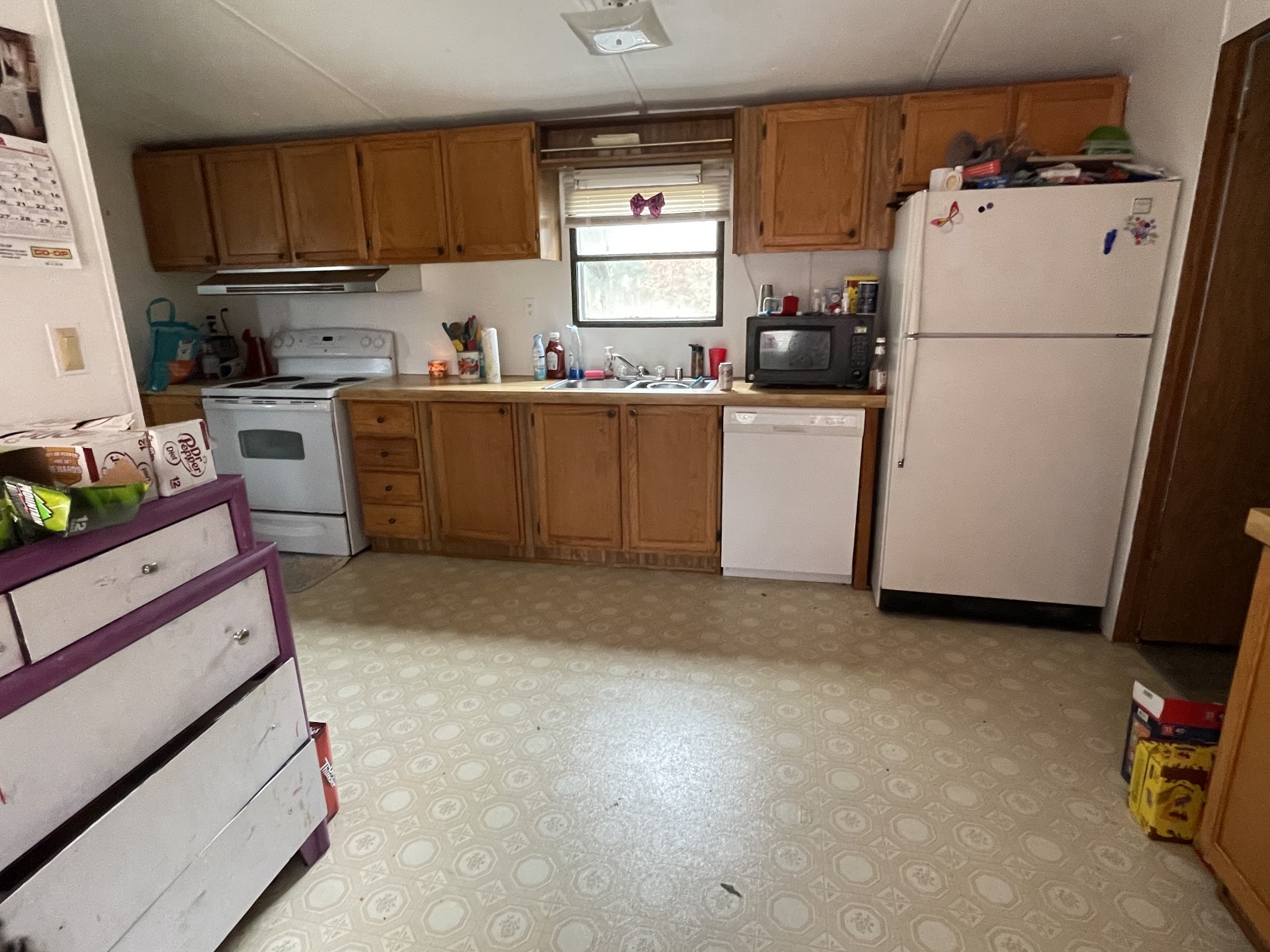 391 Pendleton Road Morrison, TN 37357 - Photo 10 of 35 a kitchen with a refrigerator a stove top oven a sink and cabinets