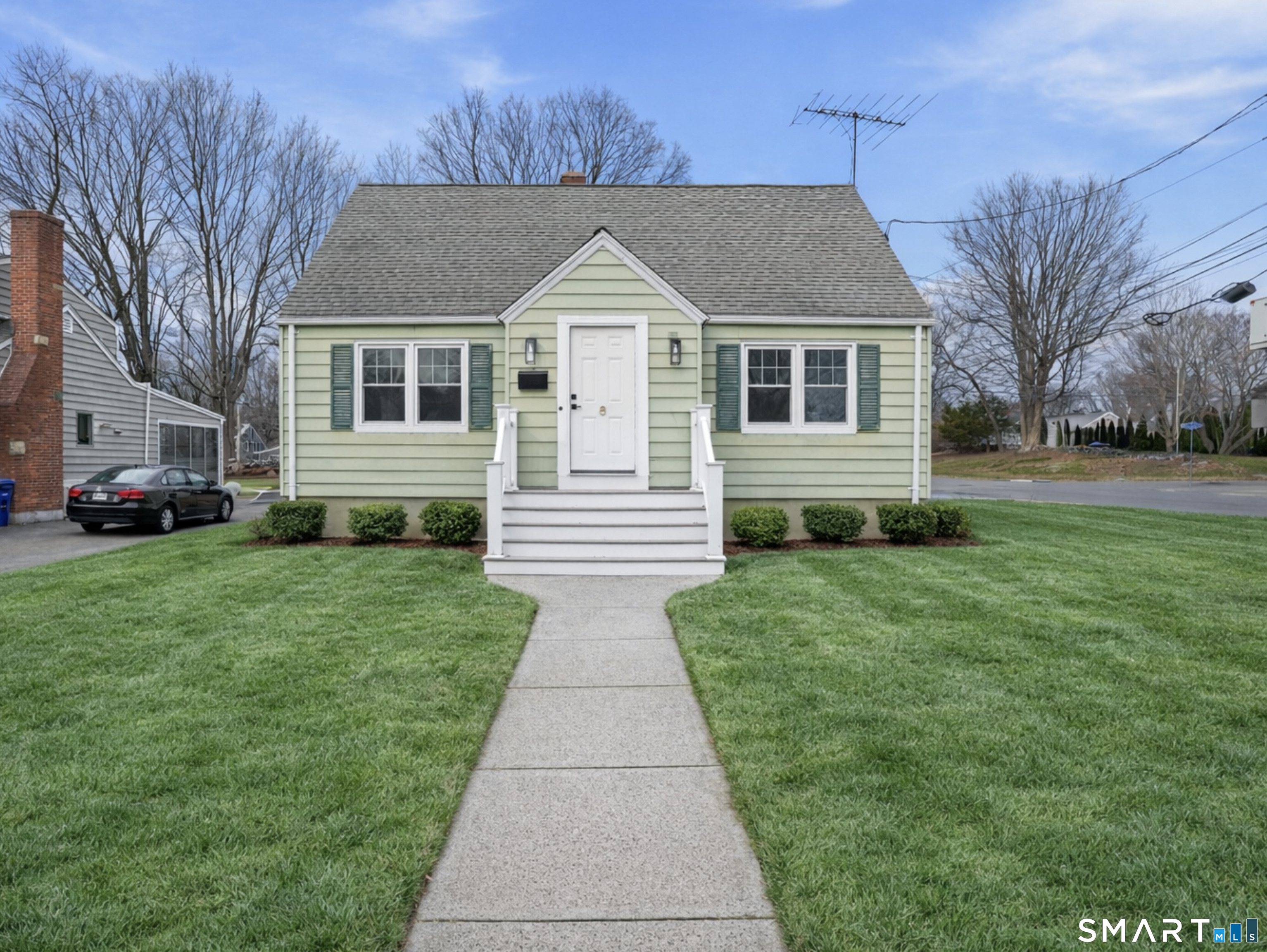 a front view of house with yard and green space