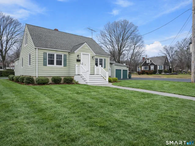 a front view of house with yard and green space