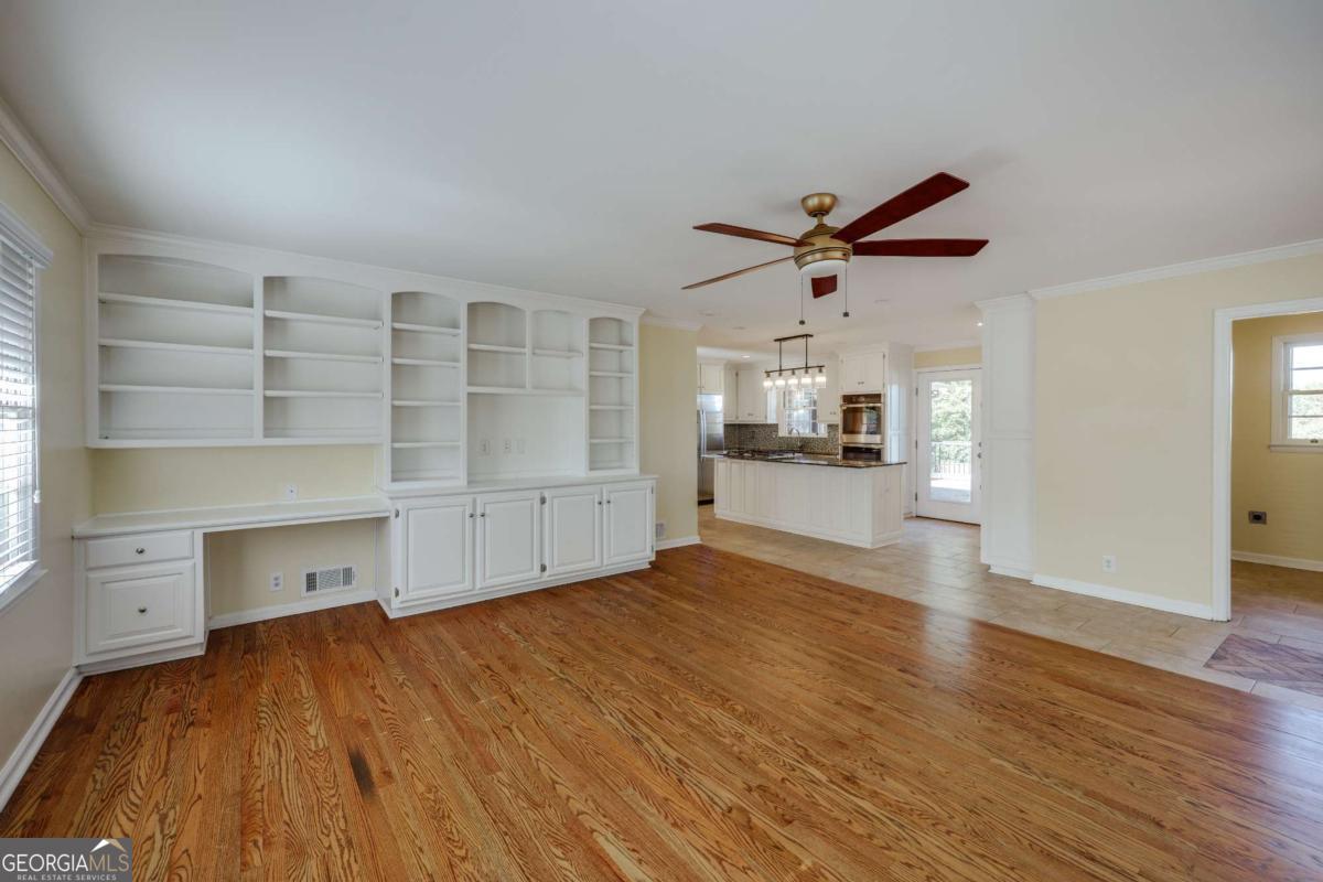 206 Fortson Drive Athens, GA 30606 - Photo 11 of 38 wooden floor in an empty room with a kitchen