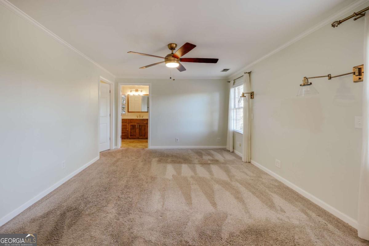 206 Fortson Drive Athens, GA 30606 - Photo 14 of 38 a view of a big room with a chandelier fan and windows
