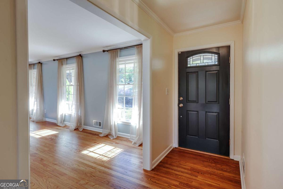 206 Fortson Drive Athens, GA 30606 - Photo 3 of 38 an empty room with wooden floor front door and windows