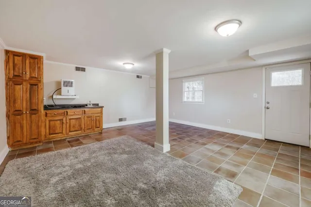 a view of a kitchen with furniture and an empty room