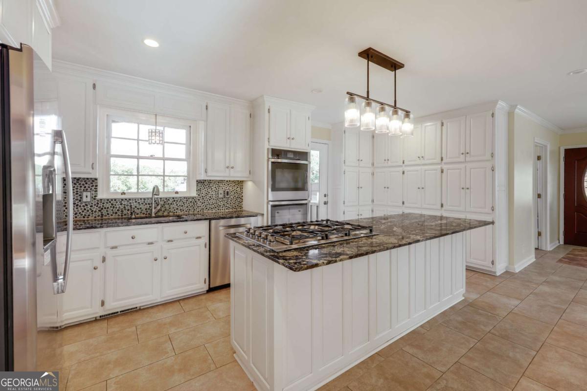 206 Fortson Drive Athens, GA 30606 - Photo 6 of 38 a kitchen with stainless steel appliances granite countertop a stove and a sink