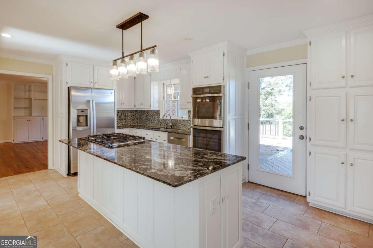 206 Fortson Drive Athens, GA 30606 - Photo 7 of 38 a kitchen with stainless steel appliances granite countertop a stove a refrigerator and a sink