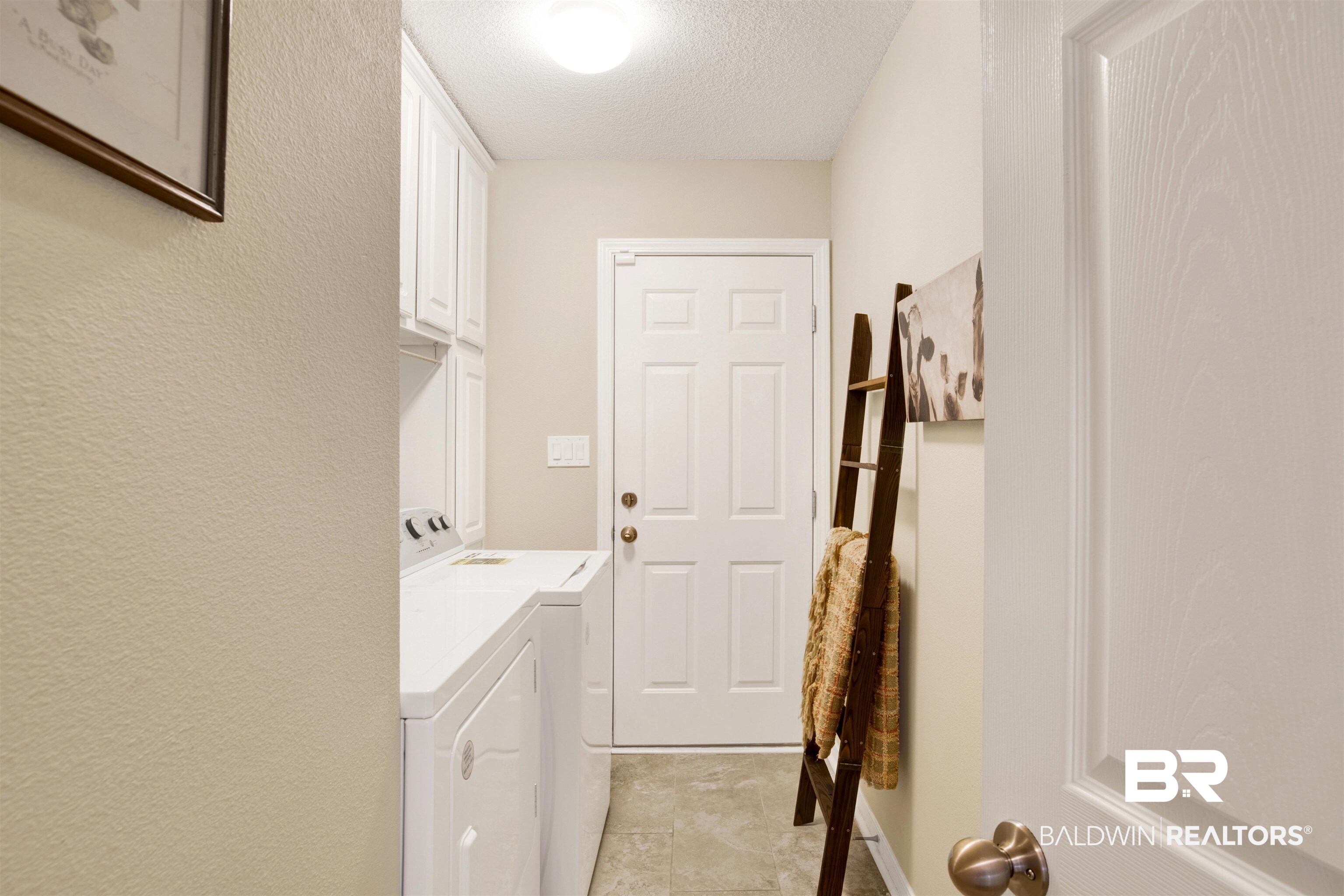 11697 Balsam Court Daphne, AL 36527 - Photo 25 of 31 Washroom featuring cabinets, separate washer and dryer, and a textured ceiling