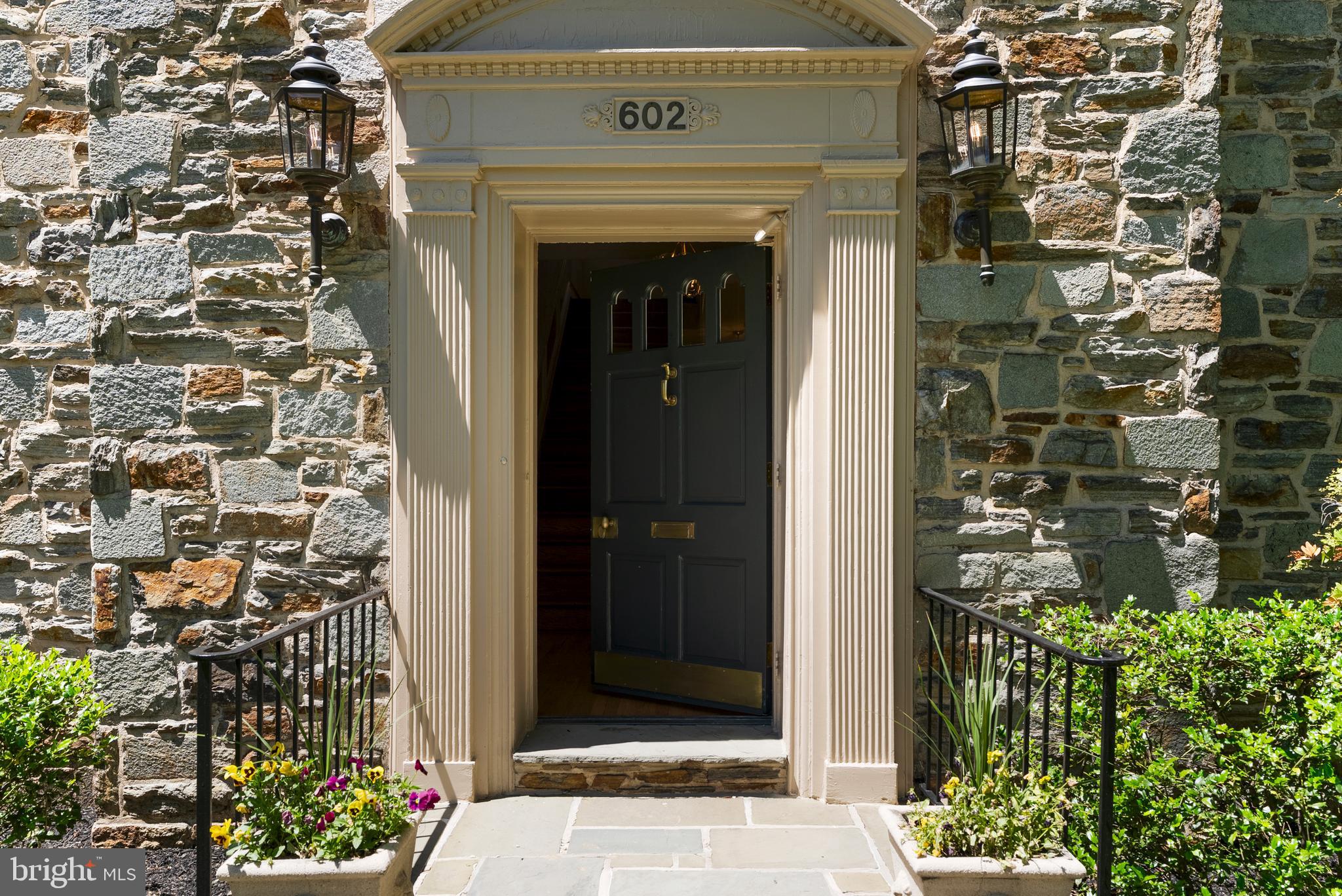 602 Stoneleigh Road Baltimore, MD 21212 - Photo 2 of 31 a front view of a house with a garden
