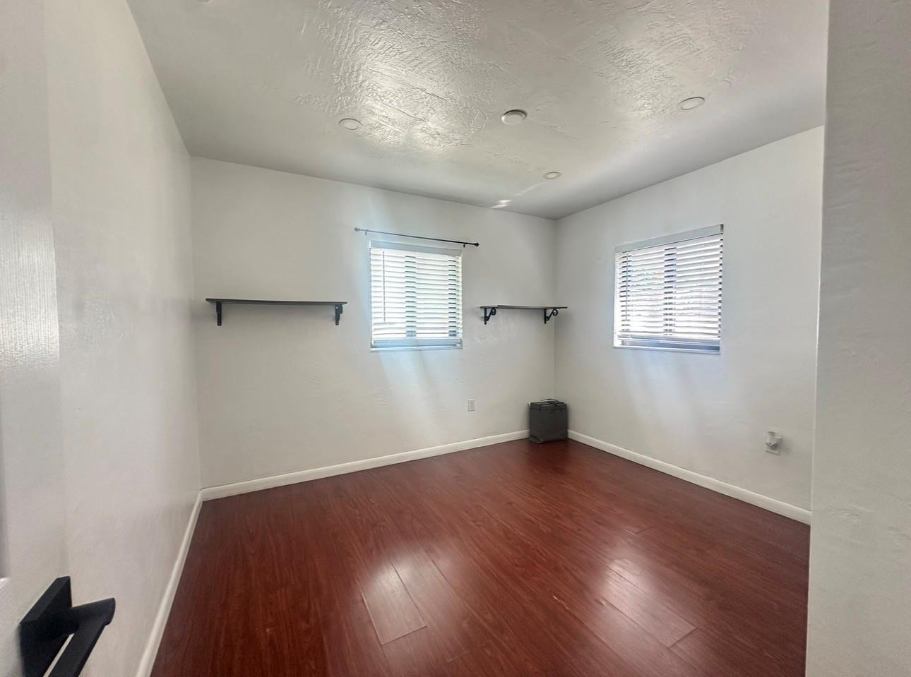 6460 Southwest 30th Street Miramar, FL 33023 - Photo 2 of 8 an empty room with wooden floor and windows