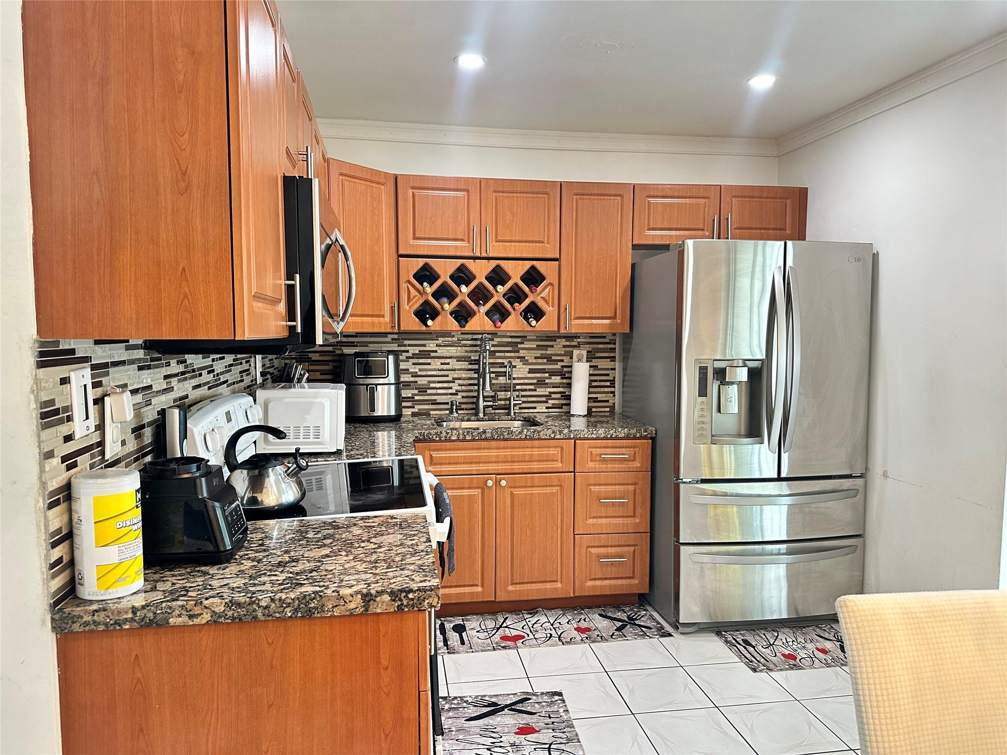 6460 Southwest 30th Street Miramar, FL 33023 - Photo 5 of 8 a kitchen with stainless steel appliances granite countertop a refrigerator and a sink