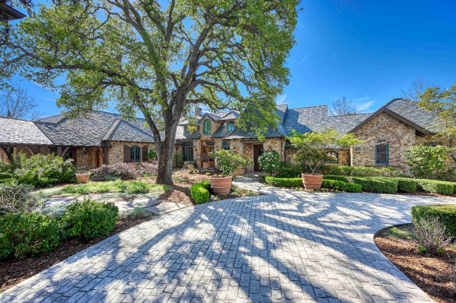 a view of a patio with table and chairs under an umbrella