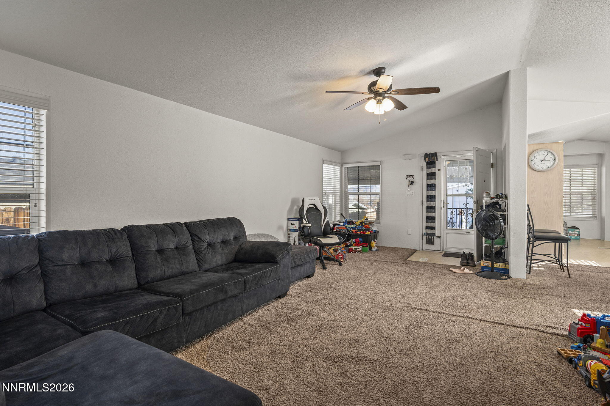 2151 Barberry Way Reno, NV 89512 - Photo 3 of 16 a living room with furniture a chandelier fan and a window