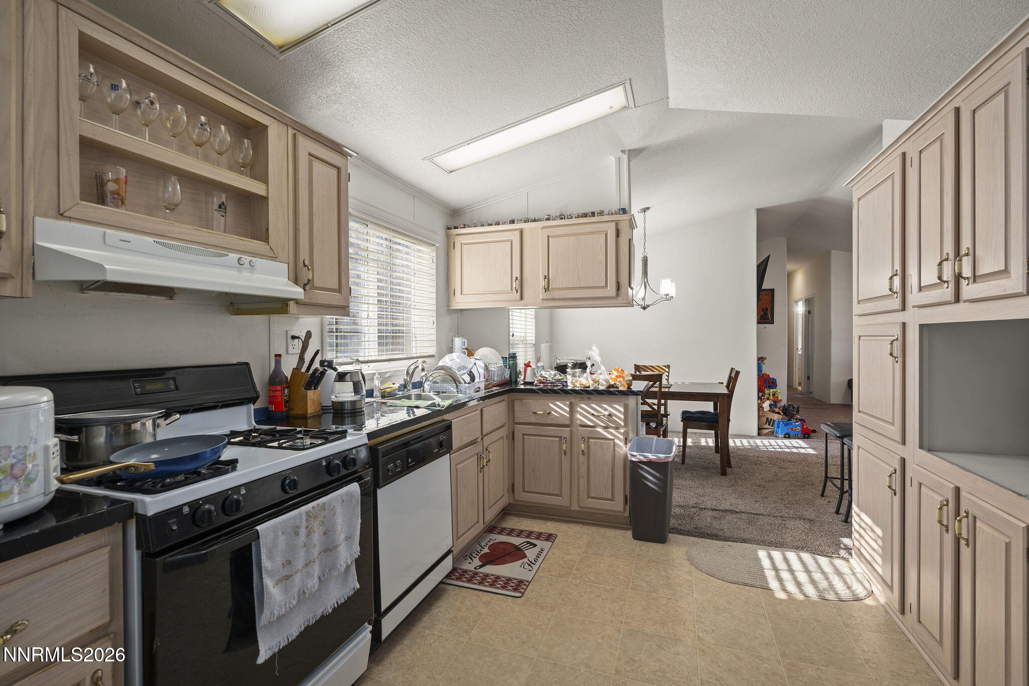 2151 Barberry Way Reno, NV 89512 - Photo 4 of 16 a kitchen with stainless steel appliances granite countertop a stove top oven a sink dishwasher and cabinets