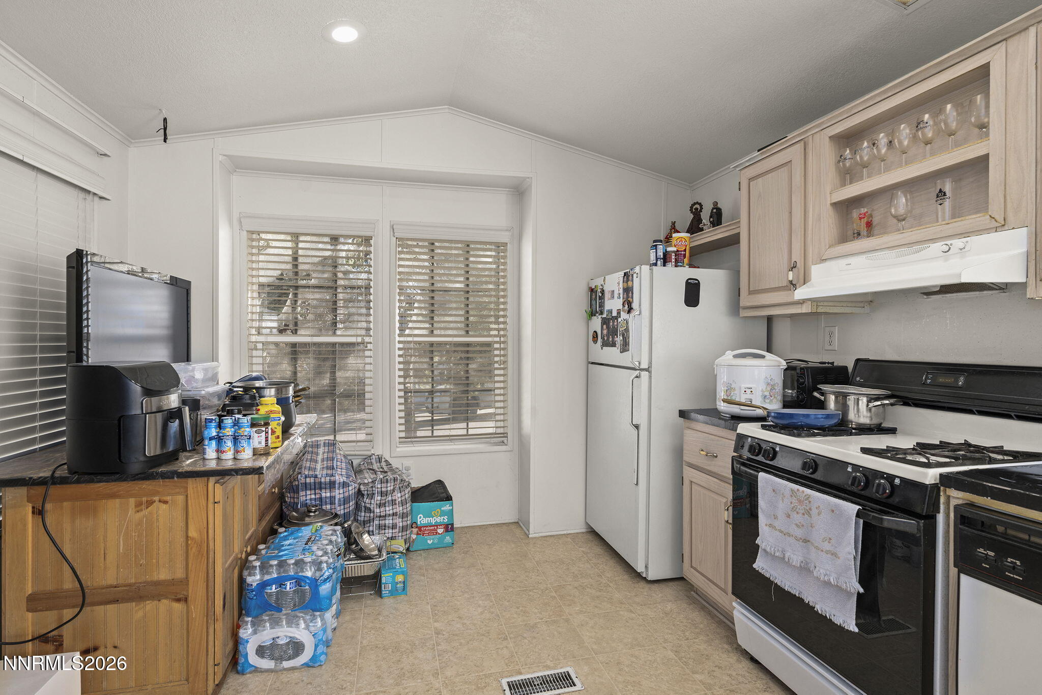 2151 Barberry Way Reno, NV 89512 - Photo 5 of 16 a kitchen with stainless steel appliances a stove a sink and a refrigerator