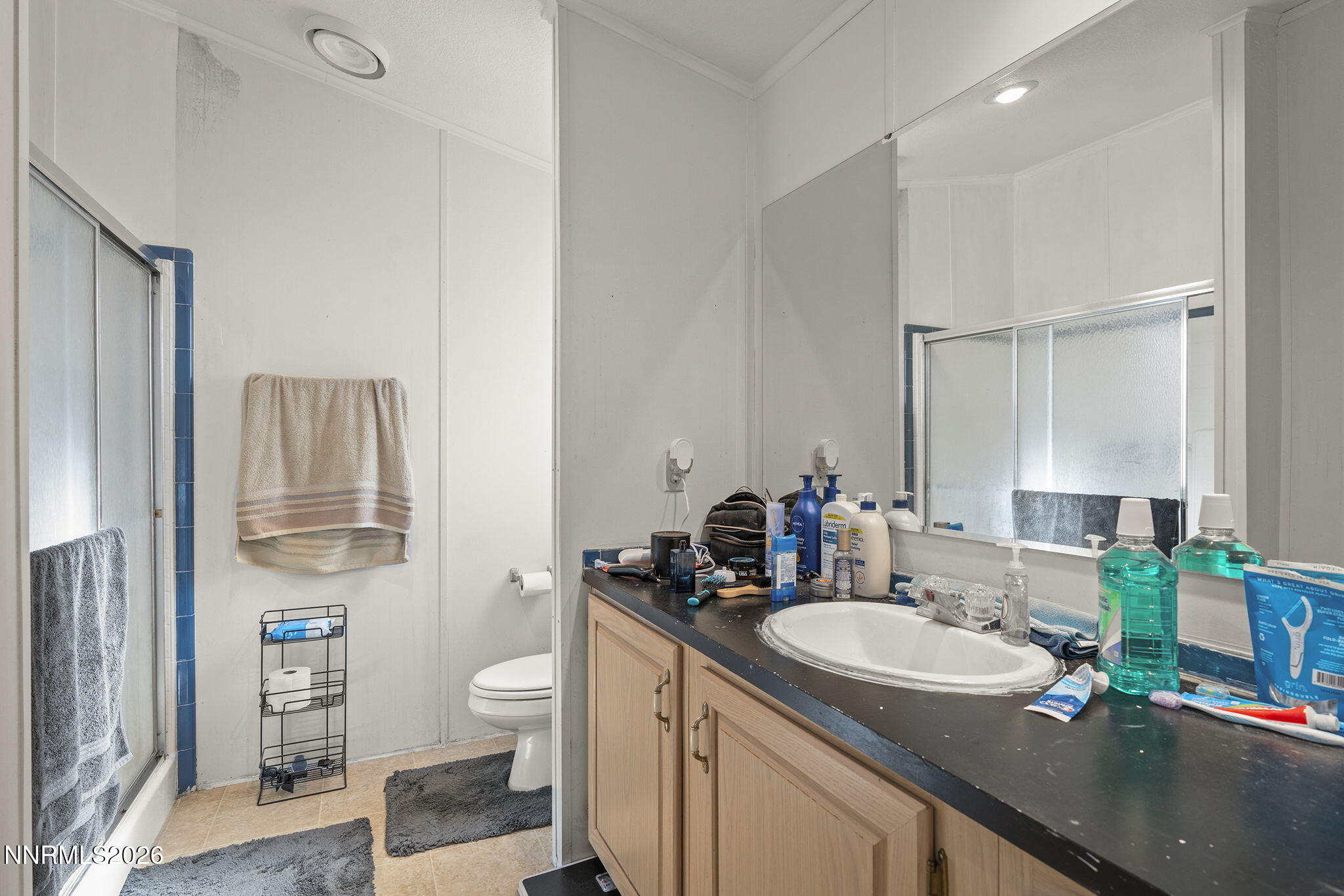 2151 Barberry Way Reno, NV 89512 - Photo 9 of 16 a bathroom with a granite countertop sink a toilet and a mirror