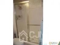 a bathroom with a glass shower door