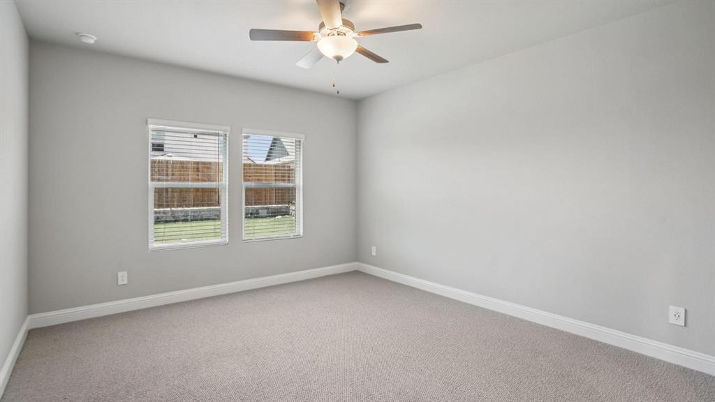 1728 Arches Road Anna, TX 75409 - Photo 8 of 11 Carpeted spare room with baseboards and a ceiling fan