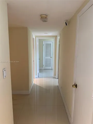a view of a hallway with wooden shelves