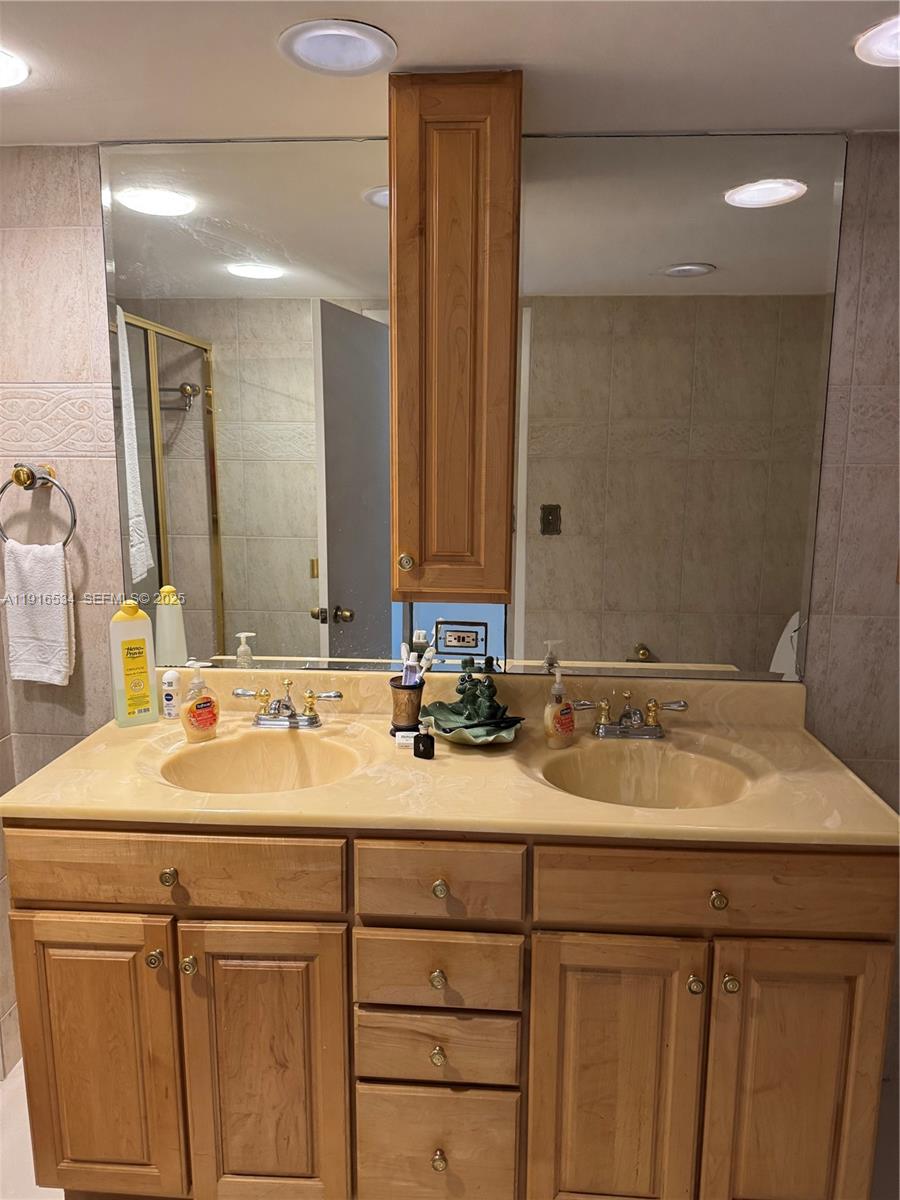 800 Northeast 195th Street, Unit 714 Miami, FL 33179 - Photo 6 of 17 a bathroom with a sink and a mirror