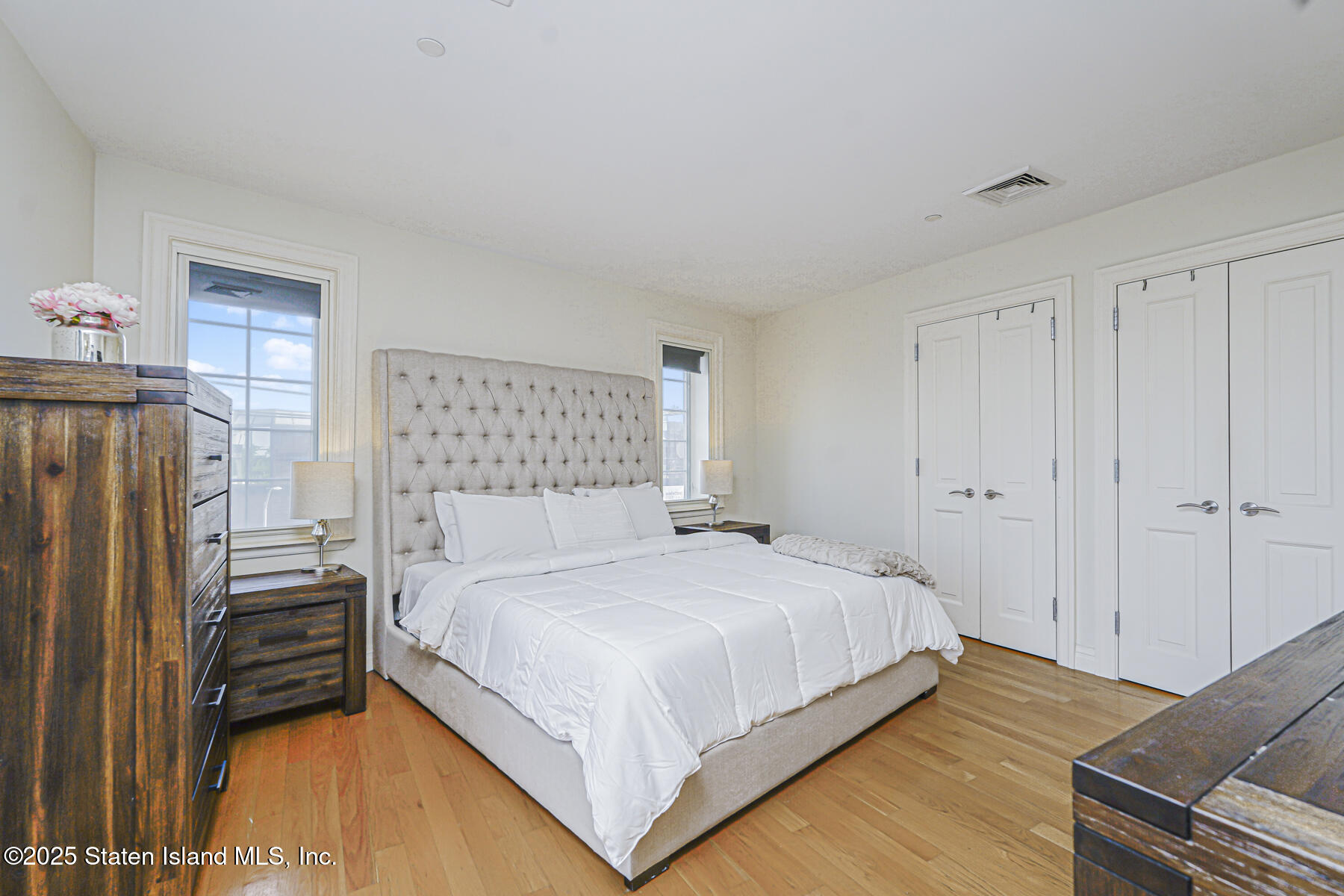 155 Bay Street, Unit 2L Staten Island, NY 10301 - Photo 24 of 32 a bedroom with a bed and a refrigerator