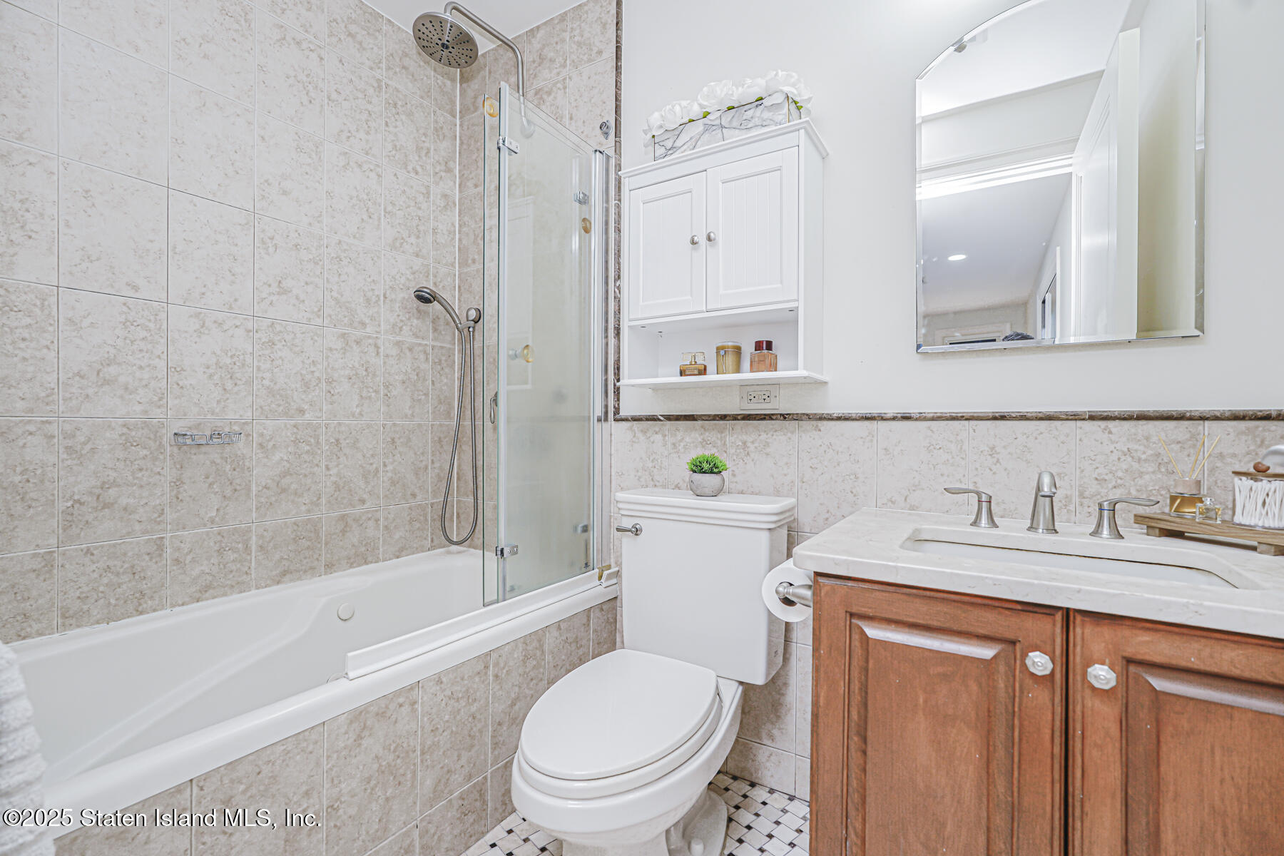 155 Bay Street, Unit 2L Staten Island, NY 10301 - Photo 26 of 32 a bathroom with a granite countertop toilet sink and mirror