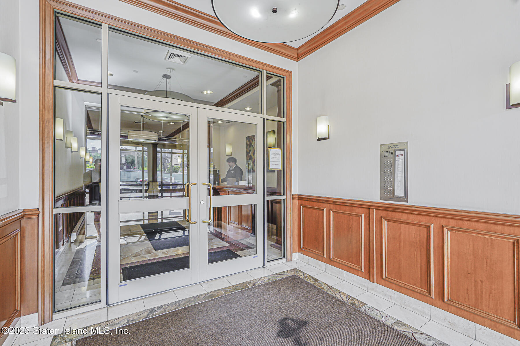 155 Bay Street, Unit 2L Staten Island, NY 10301 - Photo 3 of 32 a view of a hallway with wooden cabinets