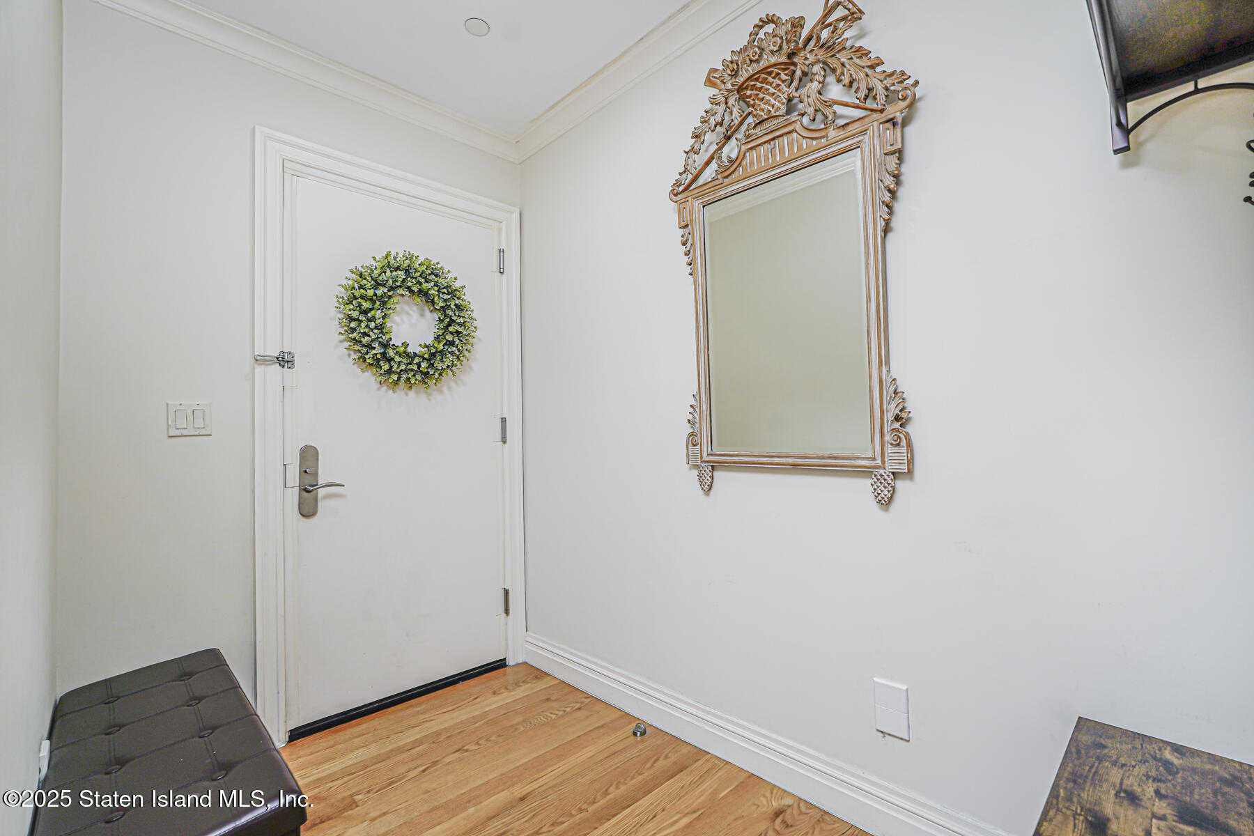 155 Bay Street, Unit 2L Staten Island, NY 10301 - Photo 7 of 32 a view of a small space with wooden floor and a window