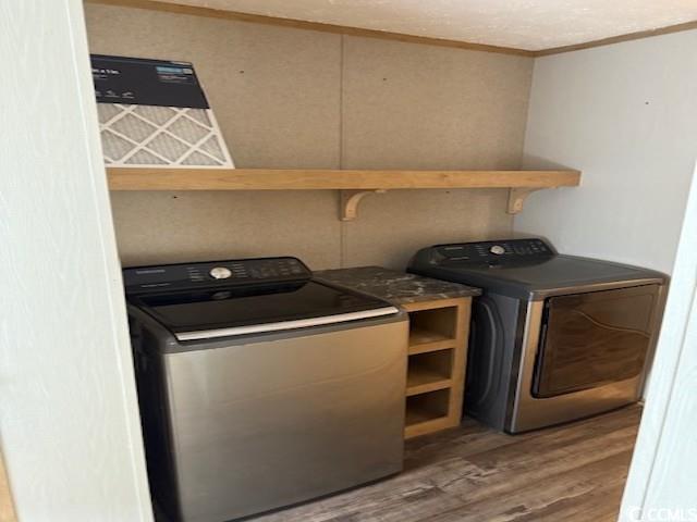 65 Clemmons Drive Tabor City, NC 28463 - Photo 13 of 29 Laundry room with ornamental molding, wood finished floors, and independent washer and dryer