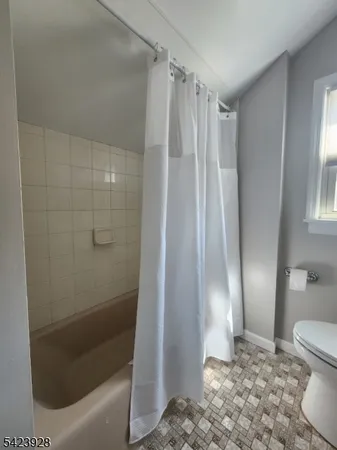 a bathroom with a shower and a toilet