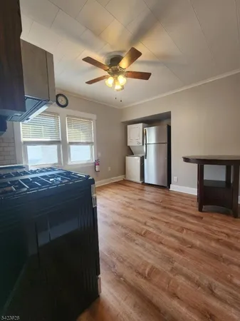 a kitchen with kitchen island a stove and a wooden floors