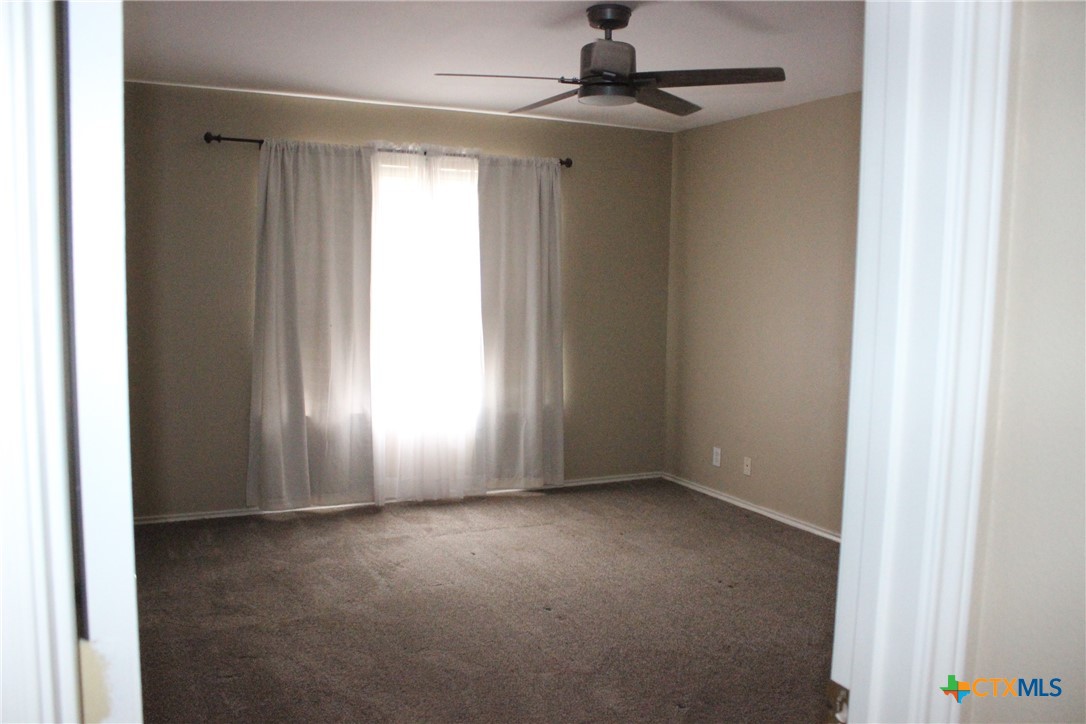 7710 Fallen Pine Converse, TX 78109 - Photo 11 of 19 an empty room with windows and fan