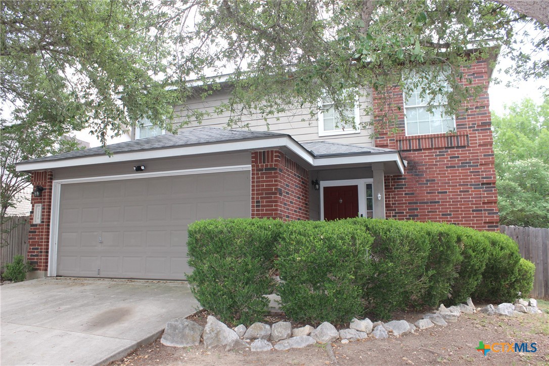 7710 Fallen Pine Converse, TX 78109 - Photo 2 of 19 a brick house with a large tree in front of it