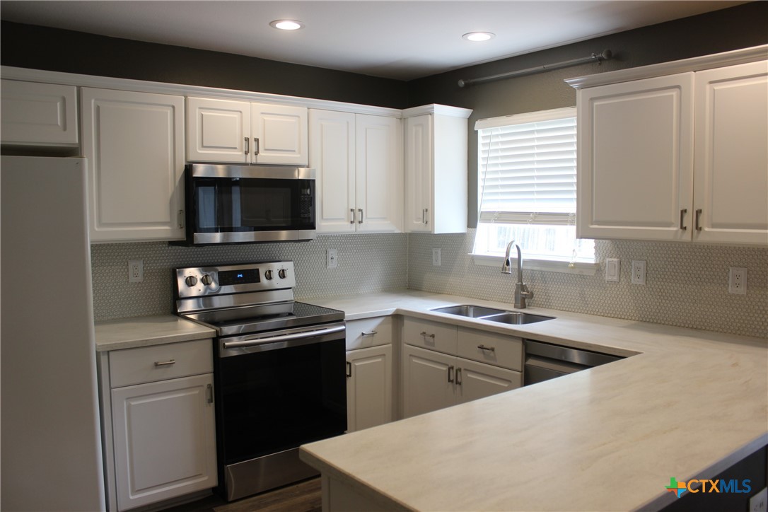 7710 Fallen Pine Converse, TX 78109 - Photo 7 of 19 a kitchen with a sink stove and microwave