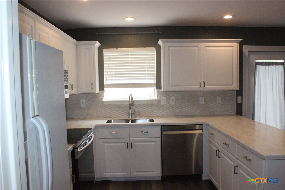 7710 Fallen Pine Converse, TX 78109 - Photo 8 of 19 a kitchen with a sink cabinets stainless steel appliances and a window