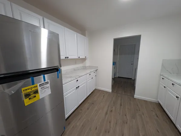 a view of kitchen with wooden floor