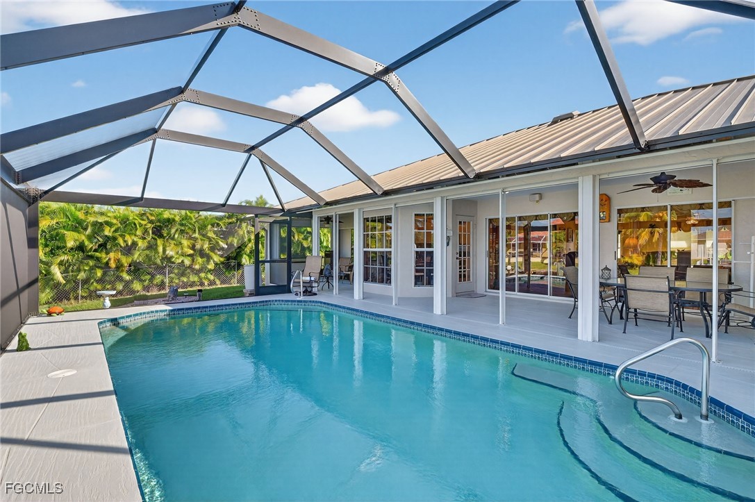 4306 Southwest 3rd Avenue Cape Coral, FL 33914 - Photo 30 of 50 a swimming pool with outdoor seating yard and patio