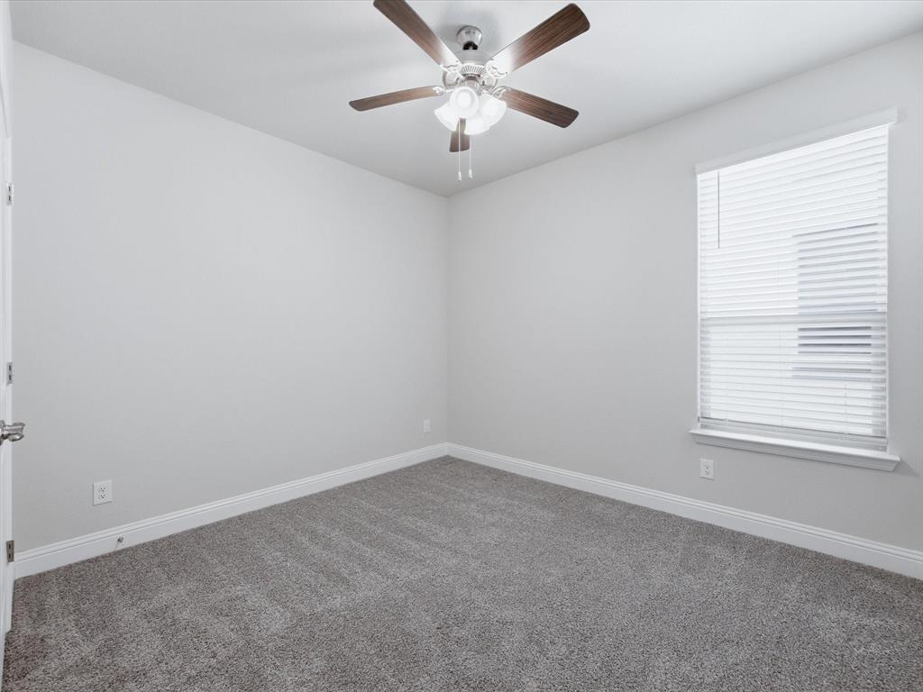 1121 Knightsbridge Road Argyle, TX 76226 - Photo 25 of 39 Bedoom featuring light gray walls, gray carpet flooring, and white baseboards