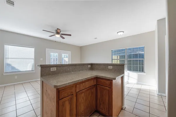a kitchen with granite countertop a sink and a stove