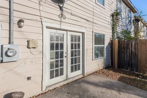a view of backyard with small cabin and wooden fence