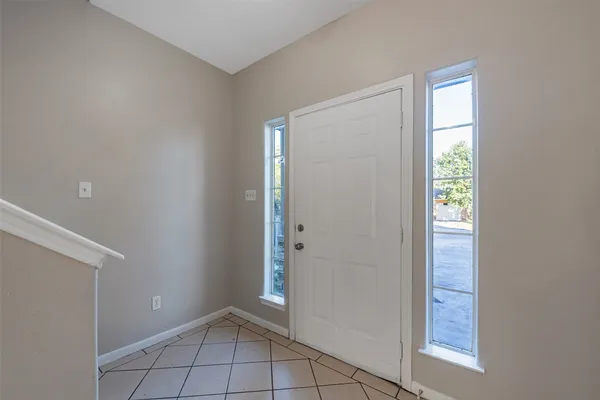 a view of an empty room with closet and a window