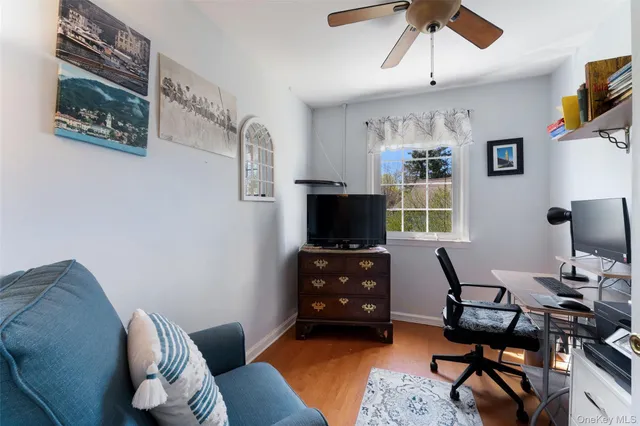 a livingroom with workspace and a window
