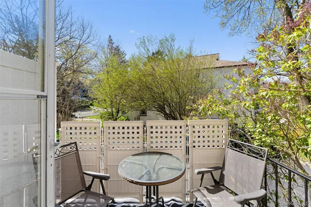 a view of a chairs and table in backyard
