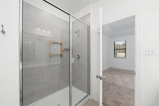 a bathroom with a double vanity sink mirror and bathtub