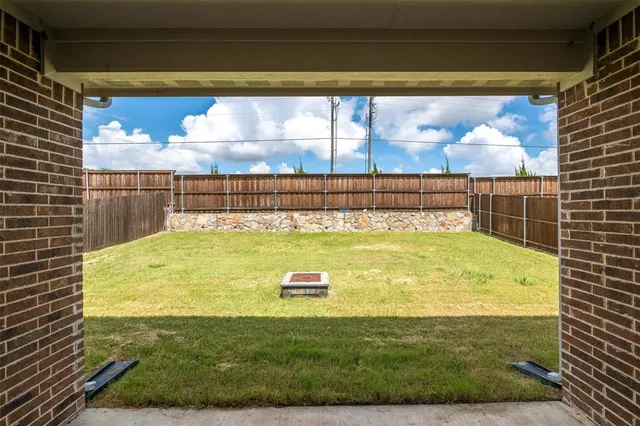 a swimming pool with outdoor seating and yard
